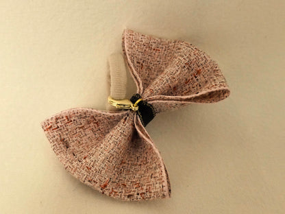 Back view of the SilkyCo Detachable dusty roseTweed Bow, showing the elastic tie and clasp.