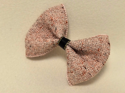 Macro detail highlighting the woven texture and gold stitching on the Dusty Rose Tweed Bow.