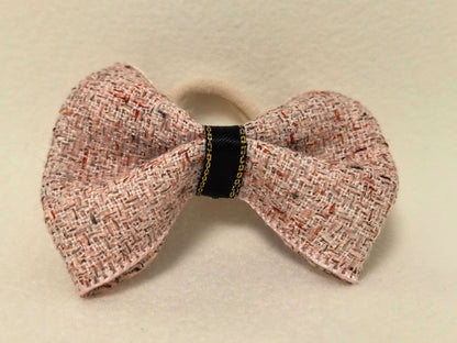 Top-down view of the SilkyCo Tweed Bow in Dusty Rose, showcasing the gold-tone clasp.