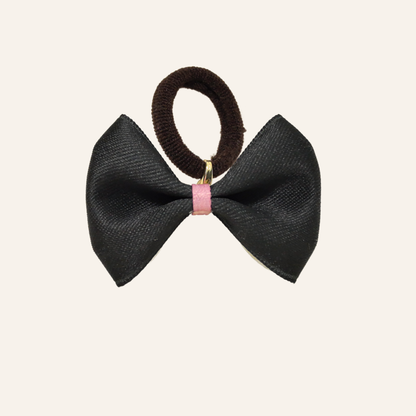 SilkyCo Detachable Two-Tone Pet Bow in Black. Fashion-forward statement piece with a pink accent ribbon and dark brown elastic tie.