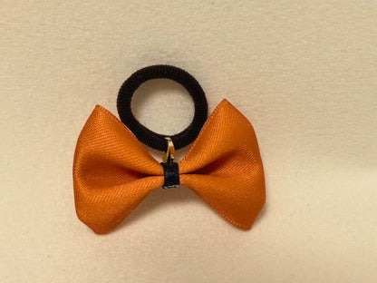 Warm Two-Tone Bow in Orange and Cream (Black accent). Cheerful and stylish, perfect for a pop of color.